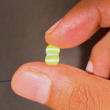 Close-up of 2.18ct twin cat’s eye gemstone with translucent honey-yellow color and distinct twin rays.