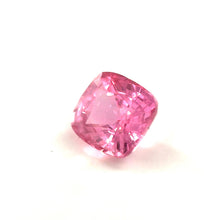 Cushion cut Padparadscha sapphire showing brilliant luster and faceting under daylight