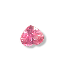 Close-up side angle of natural heart-cut Padparadscha sapphire showing pink-orange color blend and precision faceting