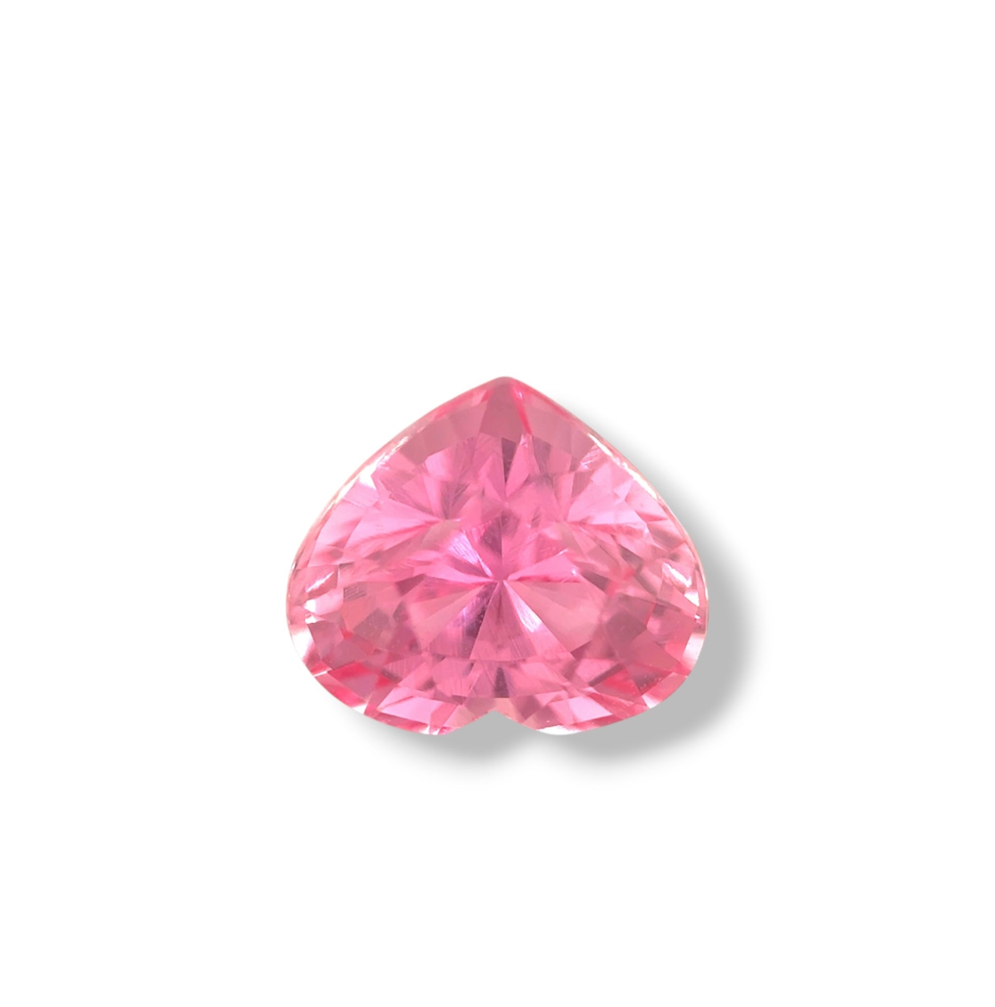 Heart-shaped Padparadscha sapphire face-up view — untreated gem with vivid salmon-peach hues and exceptional symmetry