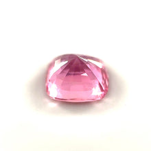 Cushion cut Padparadscha sapphire showing brilliant luster and faceting under daylight