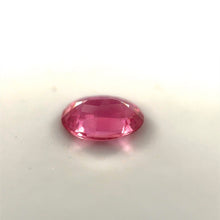 Oval cut Padparadscha sapphire showing brilliant luster and faceting under daylight